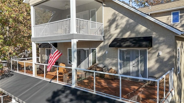 rear view of property featuring a balcony