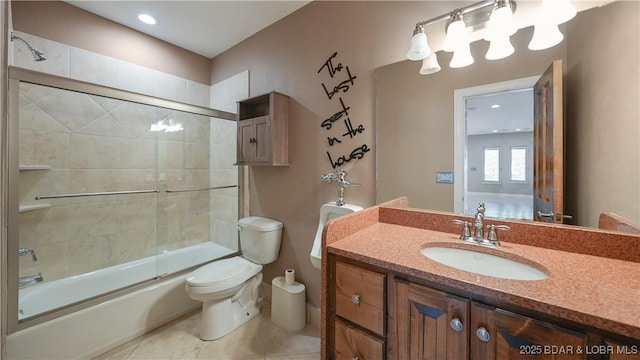 full bathroom with tile patterned floors, vanity, toilet, and combined bath / shower with glass door