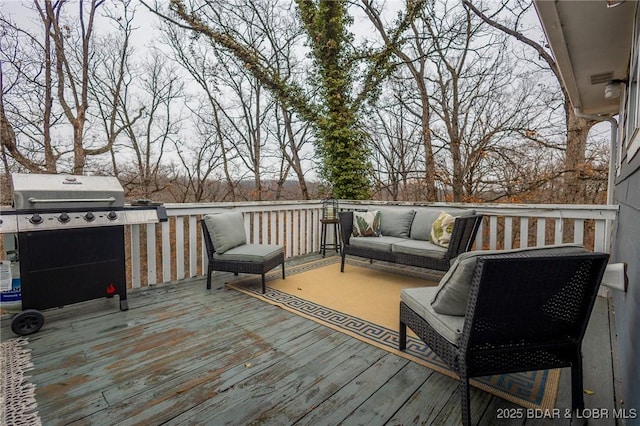 wooden terrace with outdoor lounge area and area for grilling