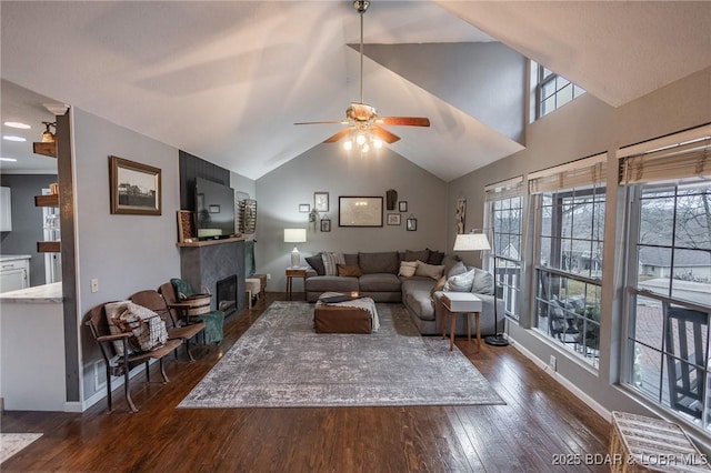 living room featuring ceiling fan, plenty of natural light, dark wood-type flooring, and high vaulted ceiling