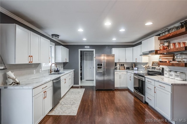 kitchen featuring stainless steel appliances, ornamental molding, white cabinets, a sink, and under cabinet range hood