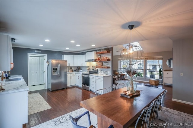 dining space featuring baseboards, dark wood finished floors, crown molding, and recessed lighting