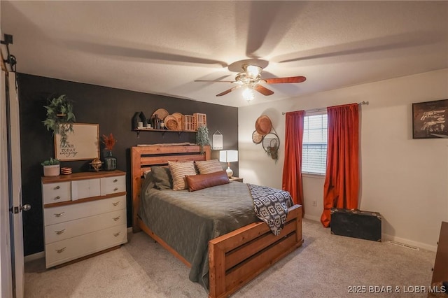 bedroom with a ceiling fan and light colored carpet