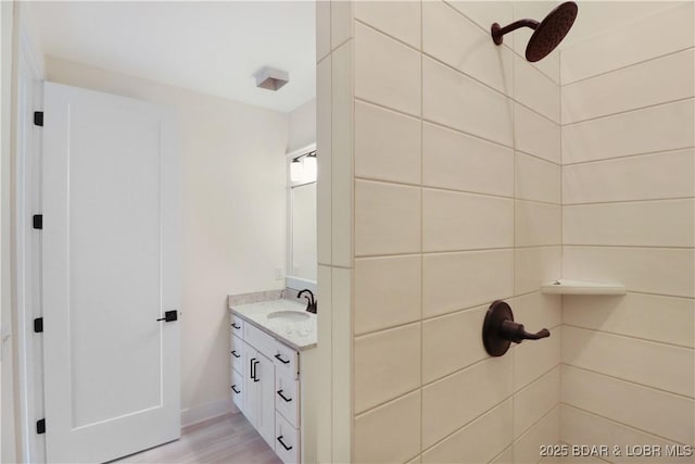 full bath with wood finished floors and vanity