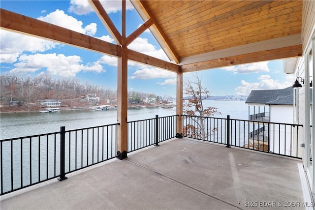 view of patio with a balcony and a water view