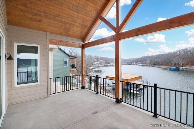 view of patio / terrace with a balcony and a water view