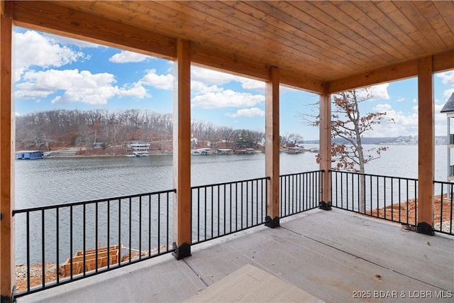 view of patio / terrace with a balcony and a water view