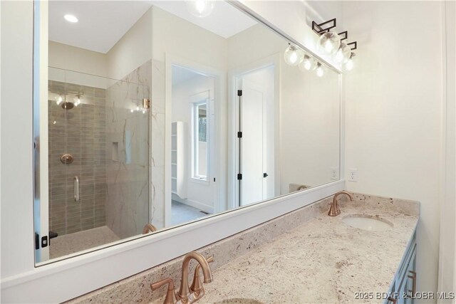 bathroom featuring an enclosed shower and vanity