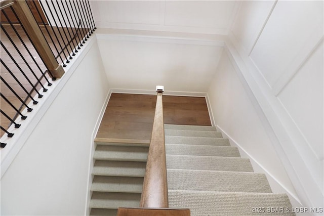 stairs featuring baseboards and wood finished floors