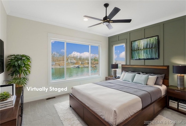 bedroom featuring visible vents, a water view, ornamental molding, light carpet, and baseboards