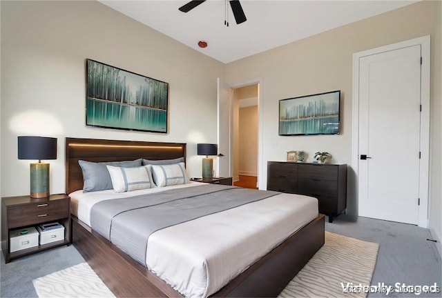 bedroom featuring dark colored carpet and a ceiling fan