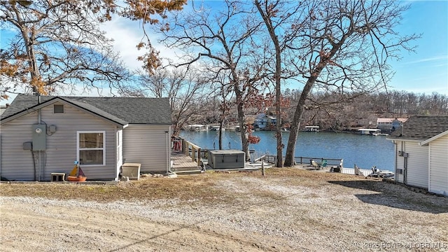 back of property with a water view