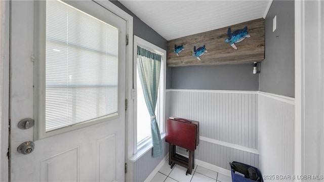 doorway to outside with plenty of natural light and light tile patterned floors