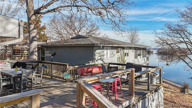 wooden deck with a water view and area for grilling