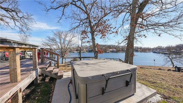 view of yard featuring a hot tub and a water view