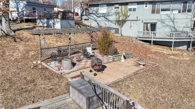 view of yard with a wooden deck, a patio, and a fire pit