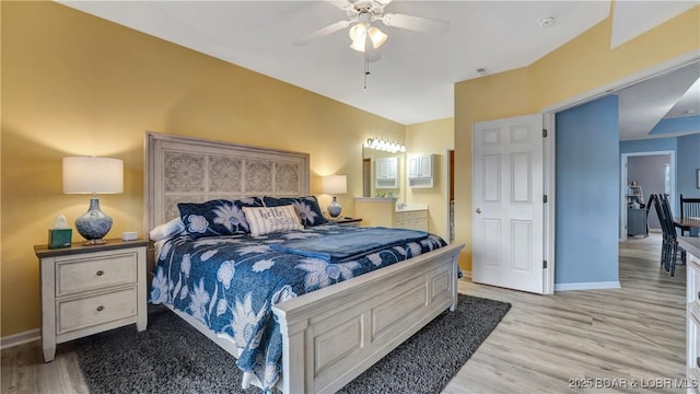 bedroom with connected bathroom, light hardwood / wood-style floors, and ceiling fan