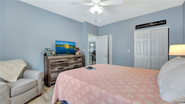 bedroom with ceiling fan, a closet, and light wood-type flooring