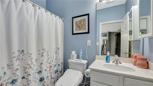 bathroom with vanity, toilet, and a shower with shower curtain