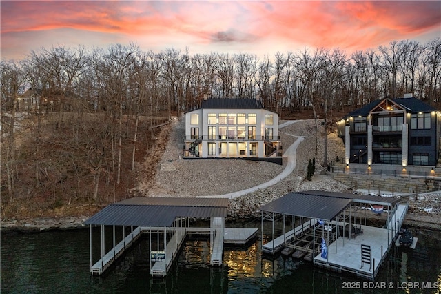 back house at dusk with a water view