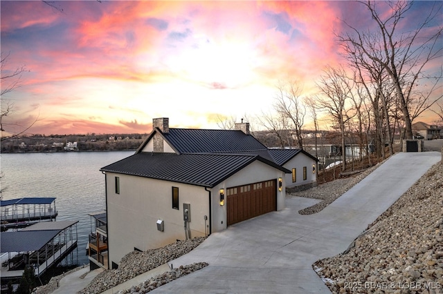 view of front facade with a garage and a water view