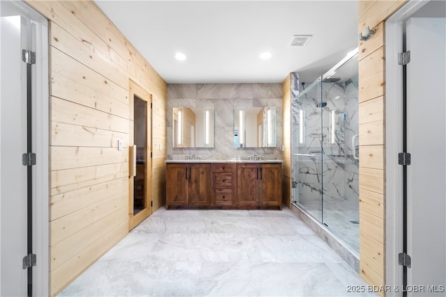 bathroom featuring vanity, wooden walls, and walk in shower