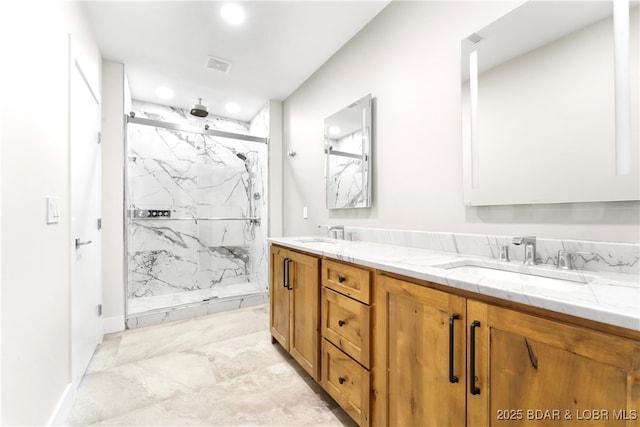 bathroom featuring a tile shower and vanity