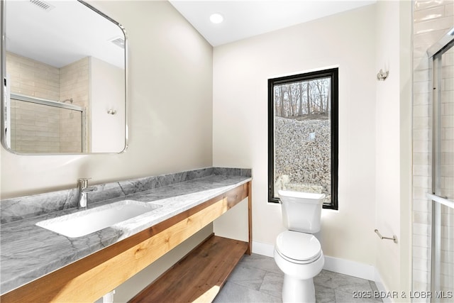 bathroom featuring walk in shower, vanity, and toilet