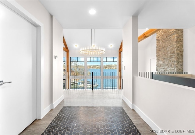 hallway with an inviting chandelier and lofted ceiling