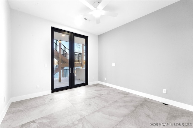 spare room with ceiling fan and french doors