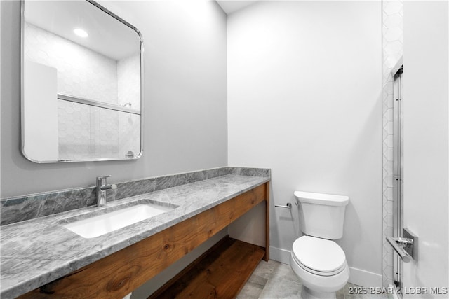 bathroom featuring vanity and toilet