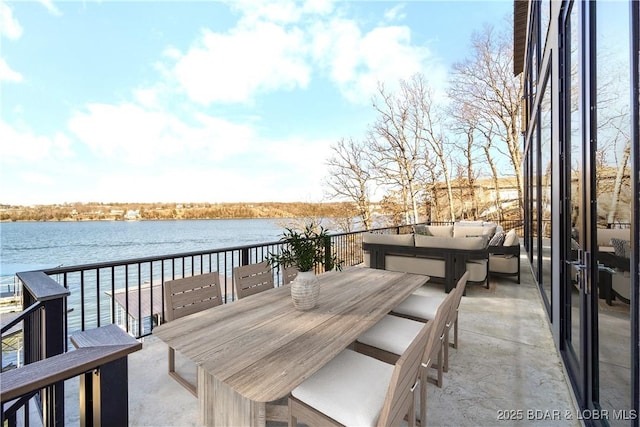 wooden terrace featuring a water view