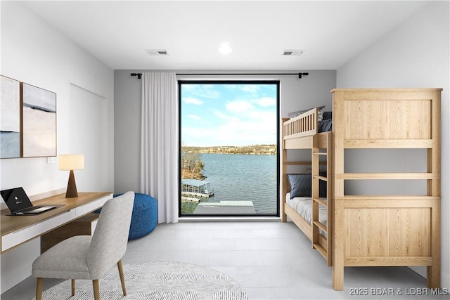 bedroom with a water view and access to exterior