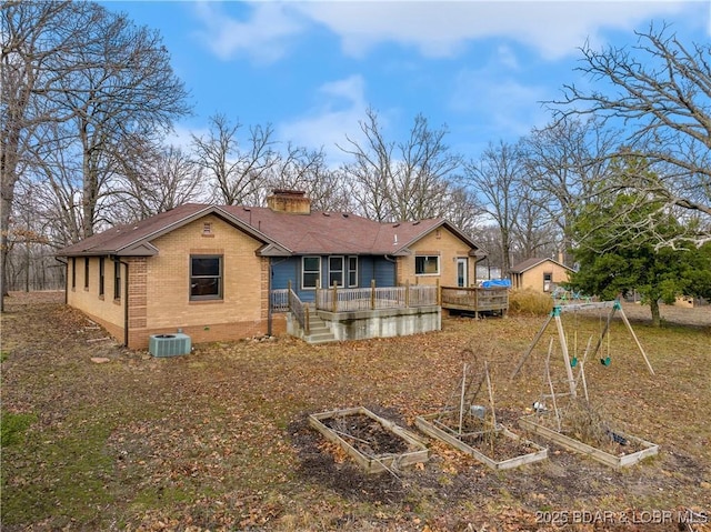 rear view of house with a wooden deck and central air condition unit