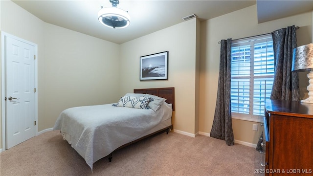 bedroom with light colored carpet