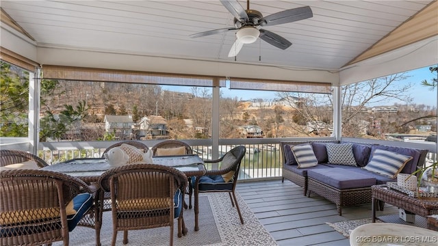 sunroom featuring lofted ceiling, a wealth of natural light, and ceiling fan