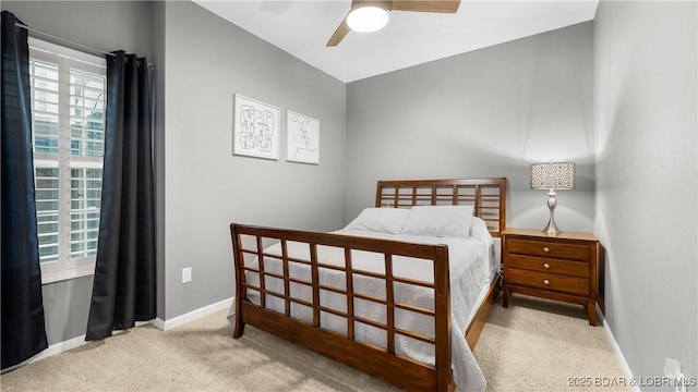 bedroom featuring ceiling fan and light colored carpet