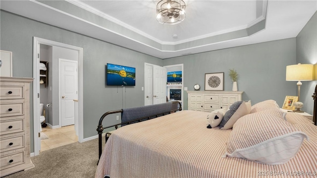 carpeted bedroom with a tray ceiling