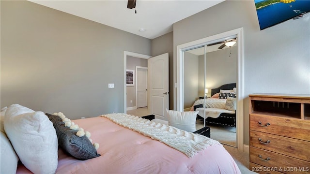 bedroom with a closet, ceiling fan, and carpet flooring