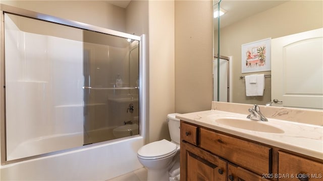 full bathroom with vanity, shower / bath combination with glass door, and toilet