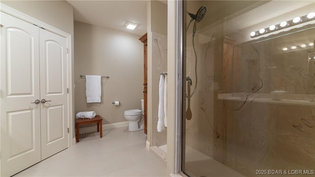 bathroom with toilet and a shower with shower door