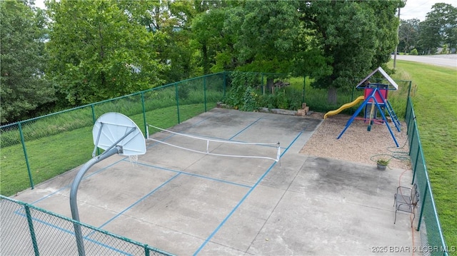 view of patio / terrace with basketball hoop and a playground