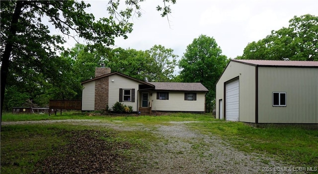 view of front of home with a garage and an outdoor structure