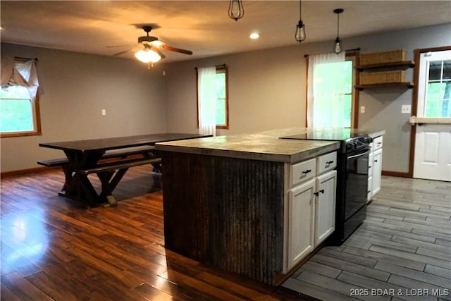 747 Paulson Dr, Edwards, MO 65326 - kitchen featuring pendant lighting, white cabinets, a center island, black range with electric stovetop, and dark wood-type flooring