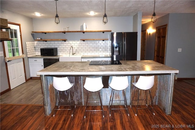 747 Paulson Dr, Edwards, MO 65326 - kitchen with white cabinets, sink, hanging light fixtures, and black appliances