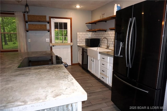 747 Paulson Dr, Edwards, MO 65326 - kitchen featuring white cabinets, a healthy amount of sunlight, hanging light fixtures, and black appliances