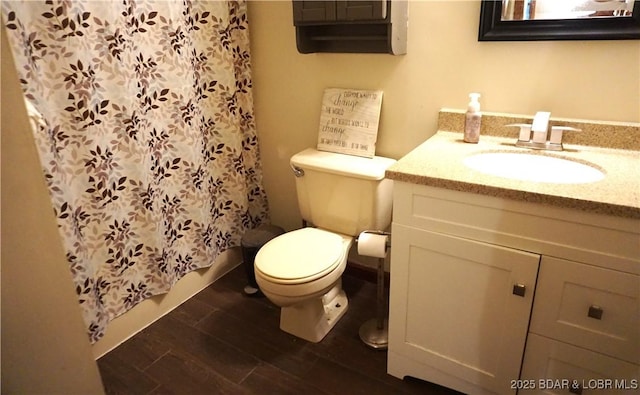 747 Paulson Dr, Edwards, MO 65326 - bathroom featuring hardwood / wood-style flooring, vanity, and toilet