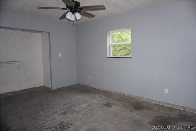 747 Paulson Dr, Edwards, MO 65326 - unfurnished bedroom with ceiling fan, a closet, and concrete floors