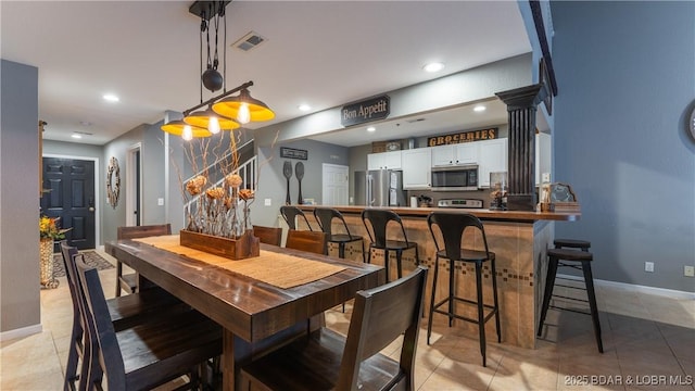 tiled dining area with ornate columns