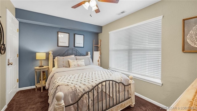 bedroom with dark colored carpet and ceiling fan